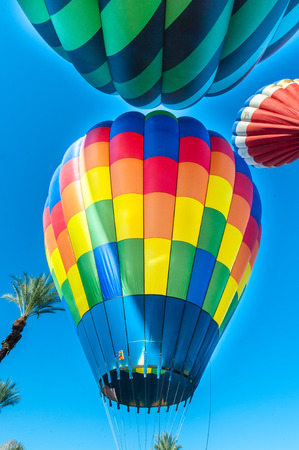 Hot air balloons take off from the desert floorの写真素材