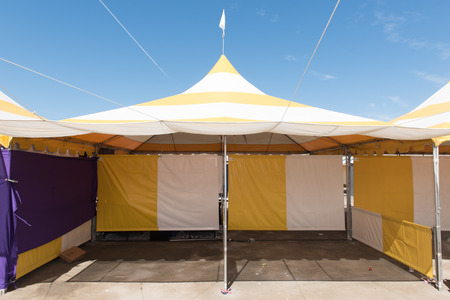 Canopy tent set up outdoors with flag on top is emptyの写真素材