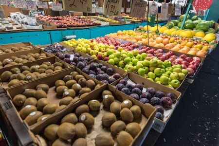 Roadside fruit stand displays many different fruitsの写真素材
