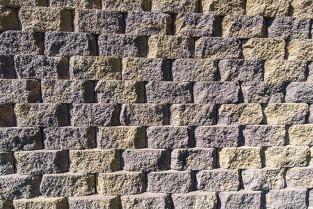 Pattern created by bricks of concrete form a wall.