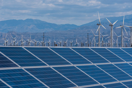 Arrays of solar panels and rows of wind turbines capture energy