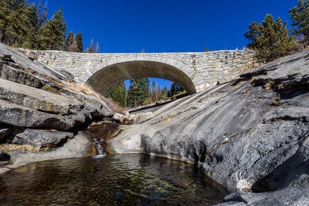 River running under a stone bridge in the California mountains.の写真素材