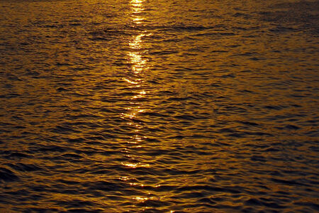 The reflection of the sun on the sea during sunset.の写真素材