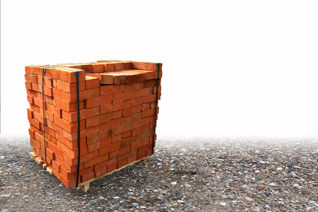 Stacked bricks on a wooden tray.の写真素材