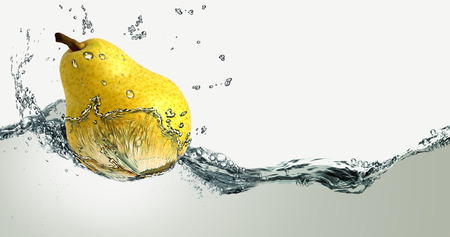 Ripe pear and splashes of water.の写真素材
