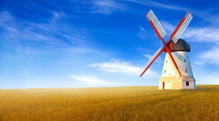 Wind white mill in a wheat field.の写真素材