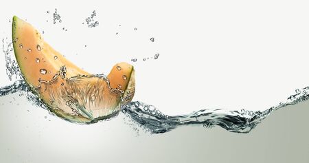 Piece of melon and water splashes.の写真素材
