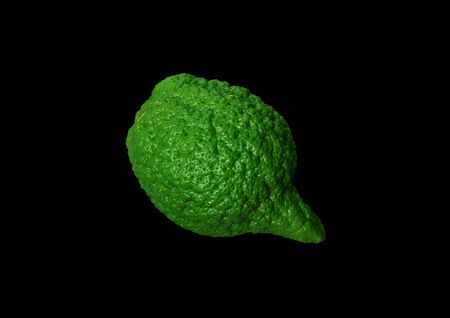 Green, citrus lemon on a black background.の写真素材