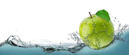 Green, juicy apple as a card on the water background.の写真素材