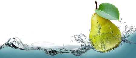 The fruit of a ripe pear on a background of splashing water.の写真素材