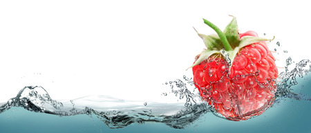 Raspberries in a spray of water.の写真素材