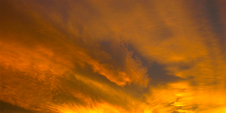 Autumn Clouds, illuminated by the sun at sunset.の写真素材
