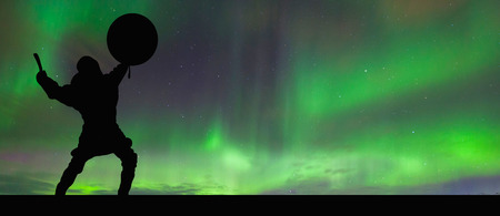 Silhouette of a witch on a background of the northern lights.の写真素材