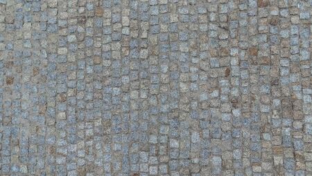 Texture of broken cobblestone road in europe.の写真素材