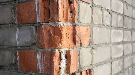 Texture of broken brickwork of an abandoned houseの写真素材
