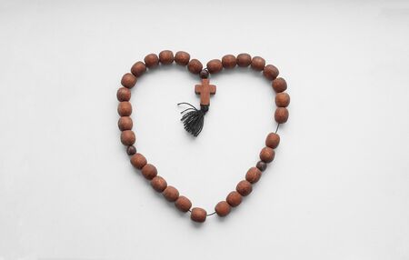 Rosary Christian mahogany with a cross on an isolated background.の写真素材