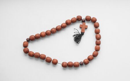 Rosary Christian mahogany with a cross on an isolated background.の写真素材