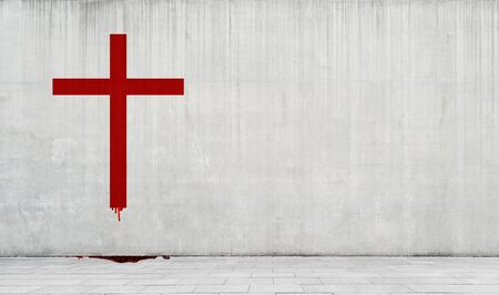 Catholic cross drawn in red paint on a concrete wall.の写真素材