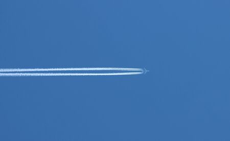 Flight of a passenger plane in the blue sky.の写真素材