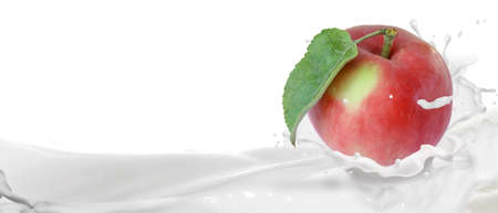 Ripe red apple in a splash of yogurtの写真素材
