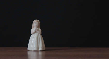 Praying girl, an old German statuette from the last century.の写真素材