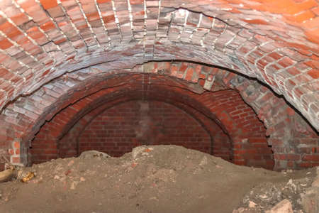 Ruins of the underground part of a medieval fortress. Ceiling vault made of bricks.の写真素材