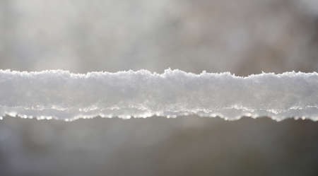 Snow lying on the wires in a winter day.の写真素材