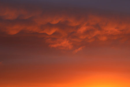 Sunrise turning morning clouds blood red, landscape.