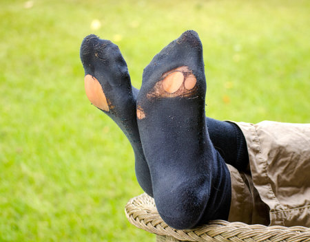 relaxing with holes in socks after a long hikeの写真素材