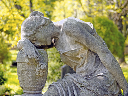 statue of a sad woman on a cemeteryの写真素材