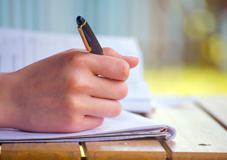 hand holding pen ready to note something