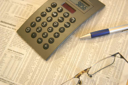 Office scene with pen, glasses and newspaperの写真素材
