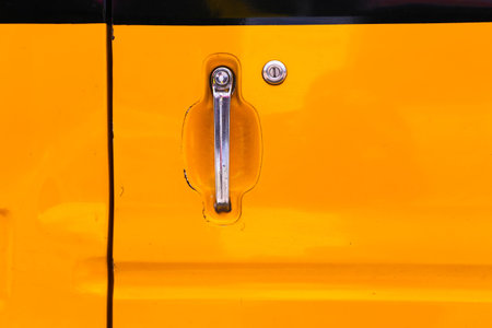 yellow car door with silver door handle