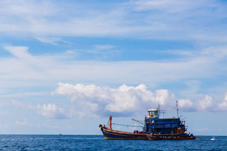 the sea and blue sky with fishing boat at koh lipe thailandの写真素材