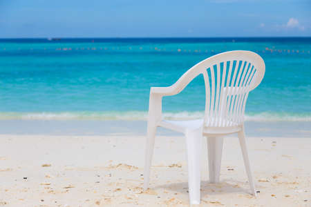 White chairs on the white sand beaches. The front of the blue sea.の写真素材