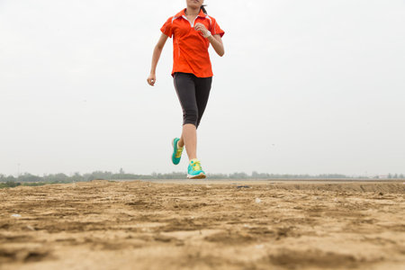 young woman running on mountain trail with white background