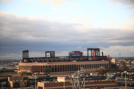 New York, September 9, 2010: Concrete and old fashioned brick Citi Field, home of the National League NY Mets. With local Queens subway trains and bridge.のeditorial素材