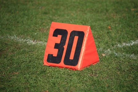 Football Field Yard Marker - Thirty 30 yard line on grass playing fieldの写真素材