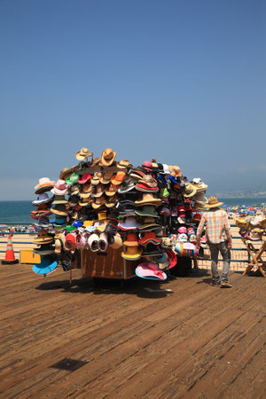 Santa Monica, California - July 1, 2012: A vendor selling beach appropriate hats on the famous Santa Monica Pier.pier のeditorial素材
