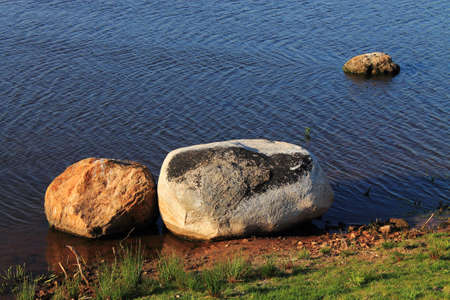 Stones and Pond - Three large stones in a pond with water ripples の写真素材