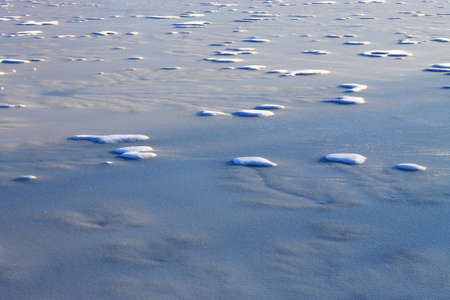 Frozen Pond - Snow and ice patterns on a winter lake.の写真素材