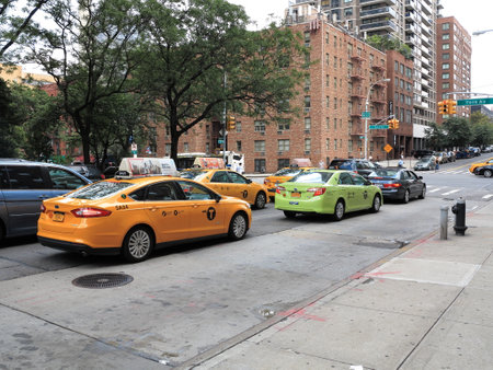 New York - August 11, 2015: Green and yellow NYC taxi cabs.のeditorial素材