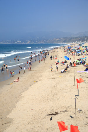 Santa Monica, California - July 1, 2012: Santa Monica beachgoers near the famous pier.のeditorial素材