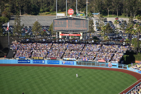 Los Angeles - June 30, 2012: A sunny day Dodgers baseball game at classic Dodger Stadium in Los Angeles, California. Featuring the outfield bleachers and classic scoreboard.のeditorial素材