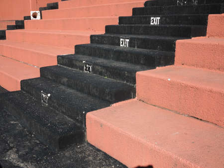 Old Fashioned Sports Seating - Hard concrete bleacher seats in an outdoor sports facility.の写真素材