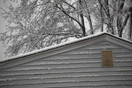 Snow on the Roof - Snowy day rooftop of a suburban house.の写真素材