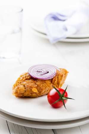 Chicken cutlet baked in cornflakes on white plateの写真素材
