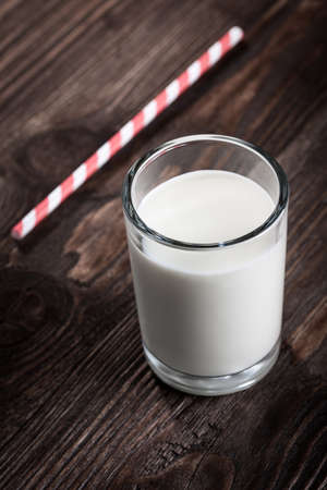 Glass of milk on wooden tableの写真素材