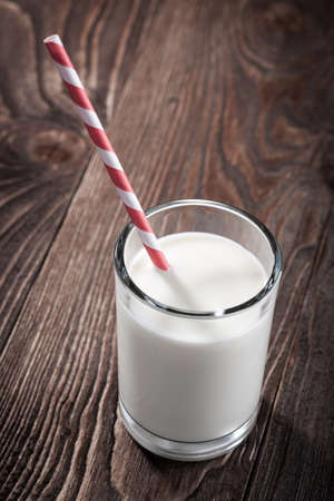 Glass of milk on wooden tableの写真素材