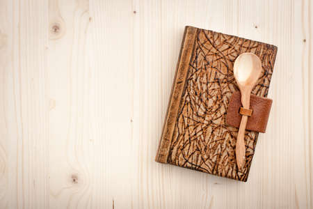 Culinary background of wooden table and notebookの写真素材